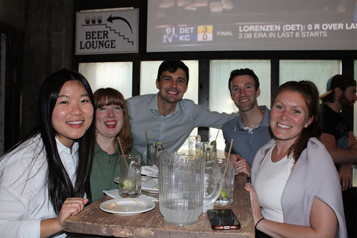 a group of people sitting at a table with wine glasses