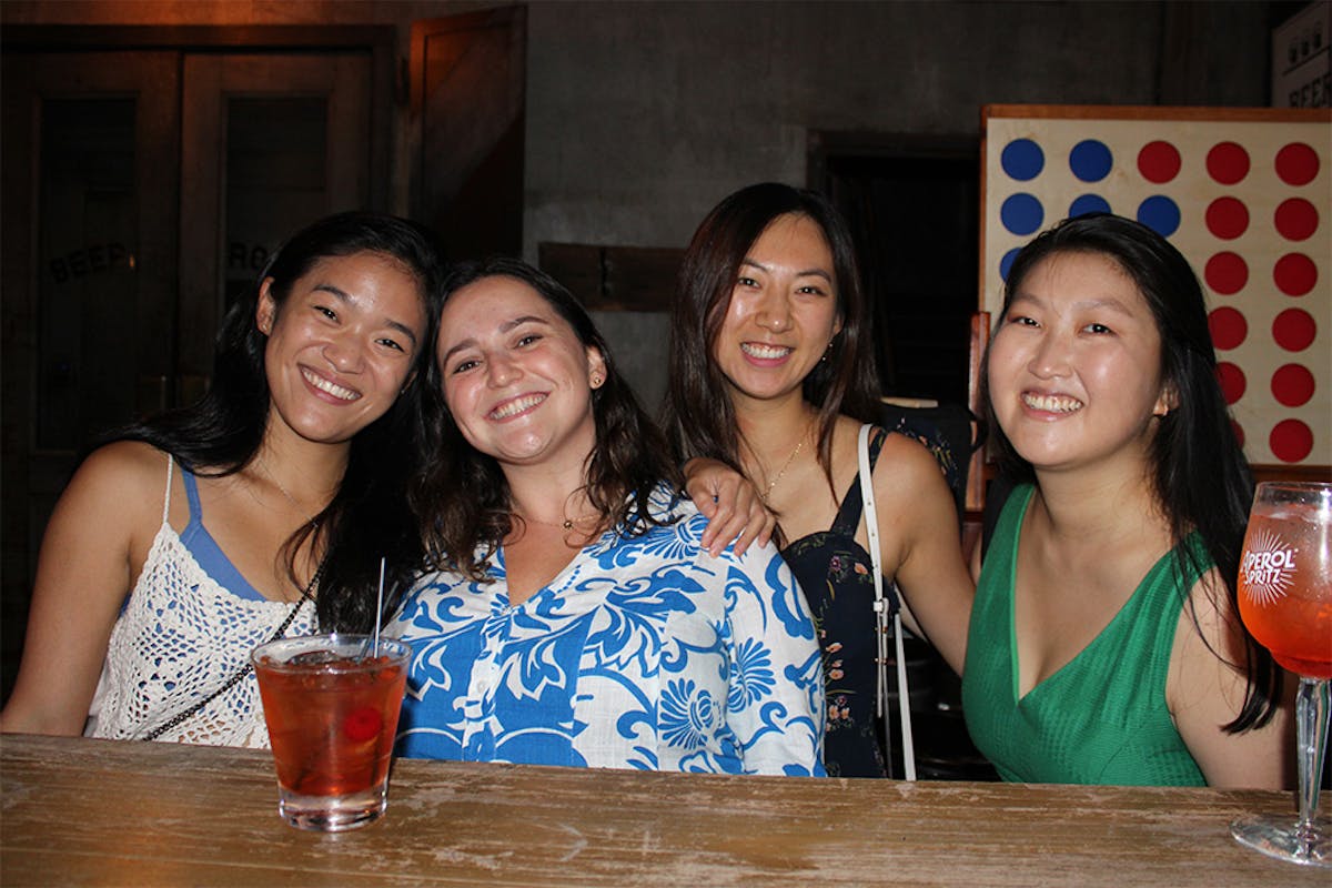 Connie Li et al. sitting at a table posing for the camera