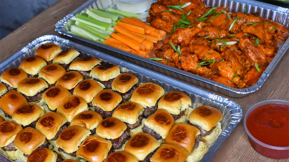 Variety of pub-style food being served for corporate catering in Little Italy, New York City.