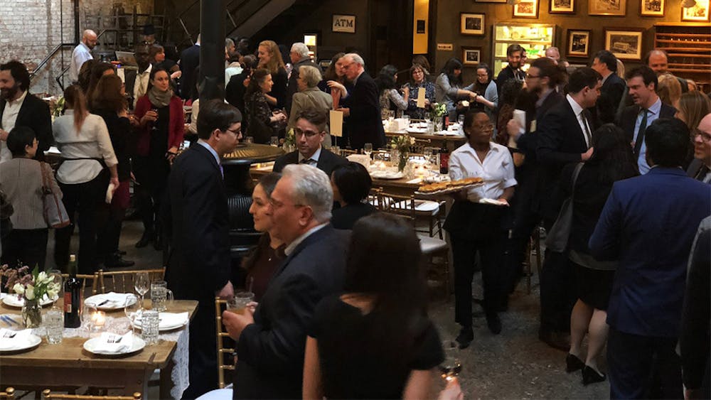 People mingling with food and drinks at our venue for parties near Hudson Square, New York City.