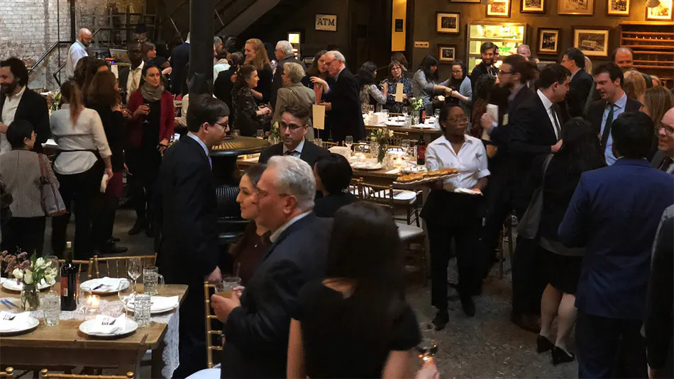 People mingling with food and drinks at our venue for parties near Manhattan, New York City.