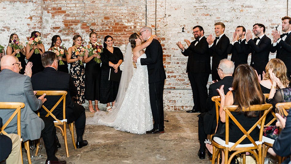 The bridge and groom kissing during the ceremony at our top wedding venue near Midtown South, New York City.