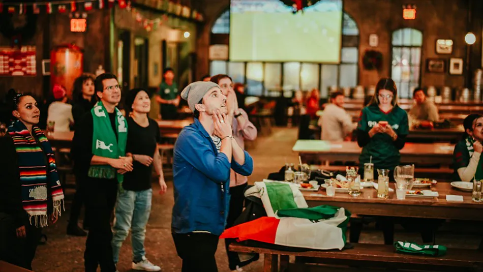A group of soccer fans at a World Cup watch party near Flatiron District, New York City.