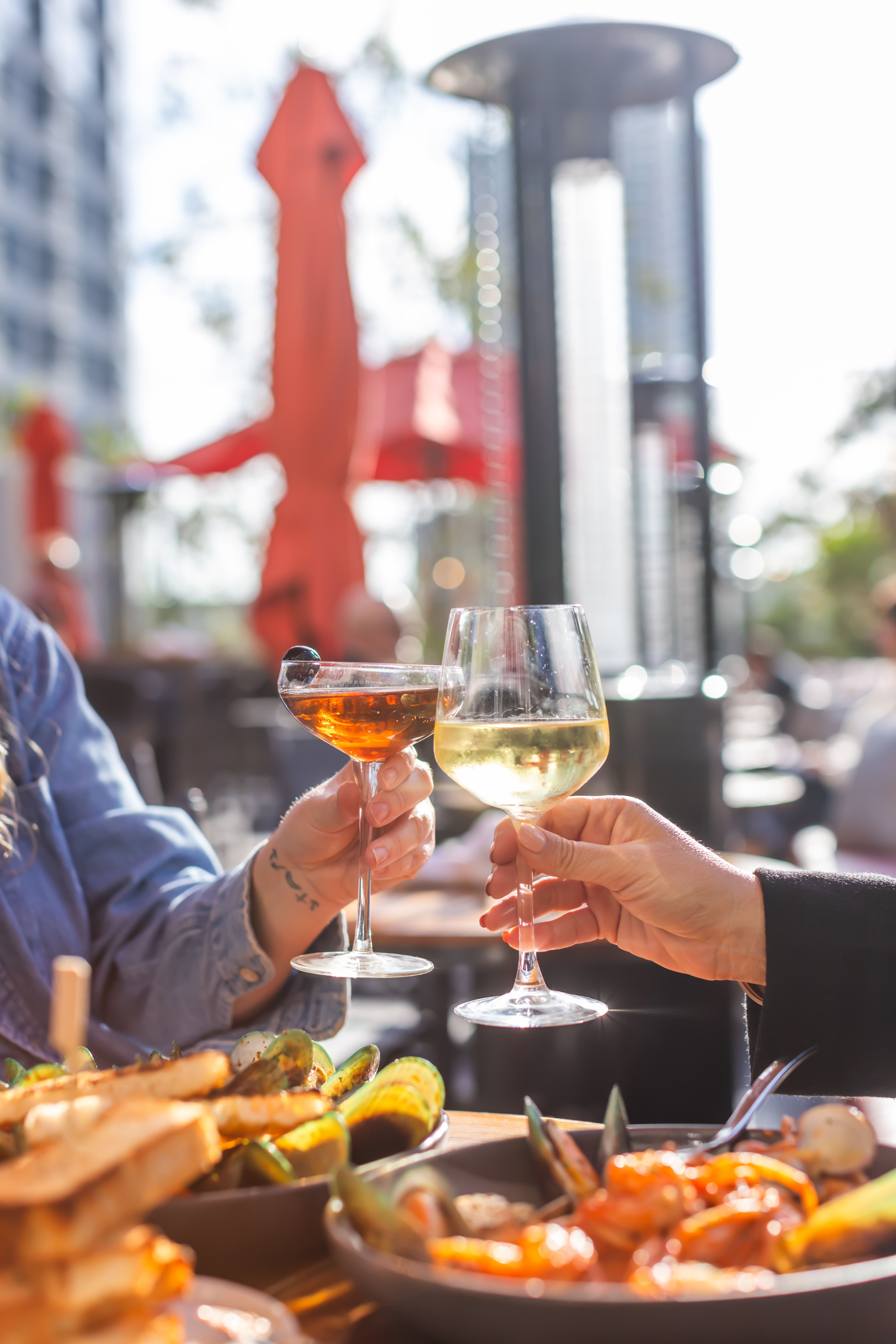 a couple of people toasting with wine glasses