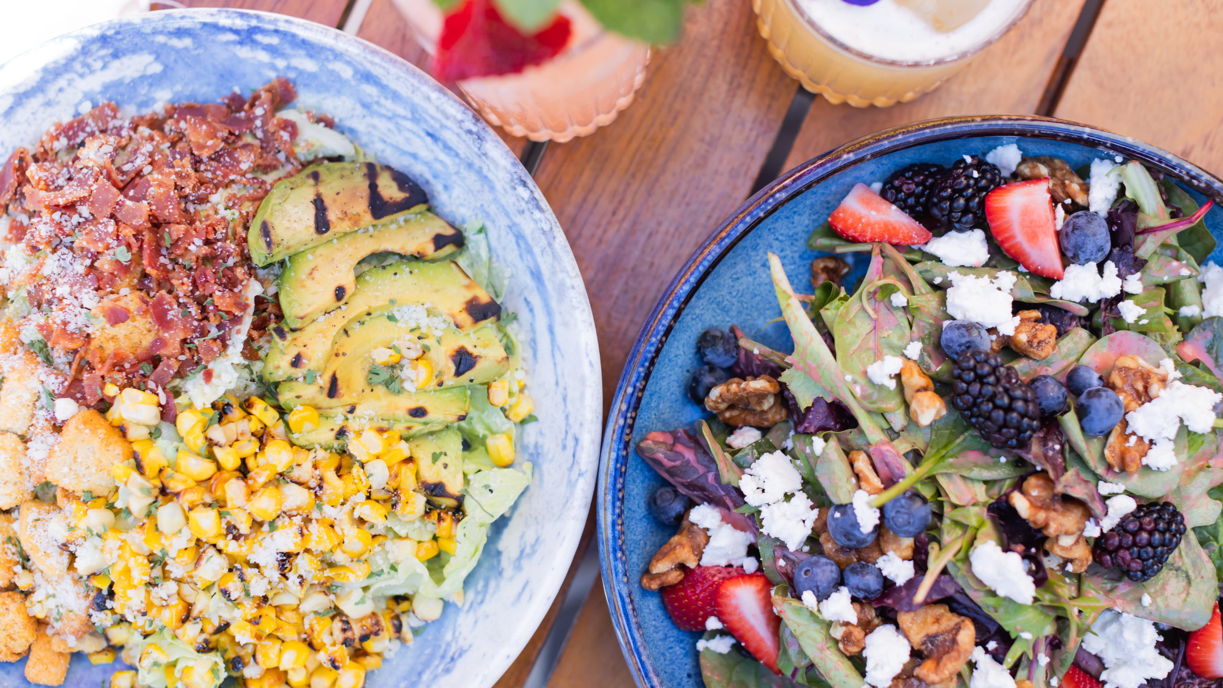 two bowls of salad and fruit