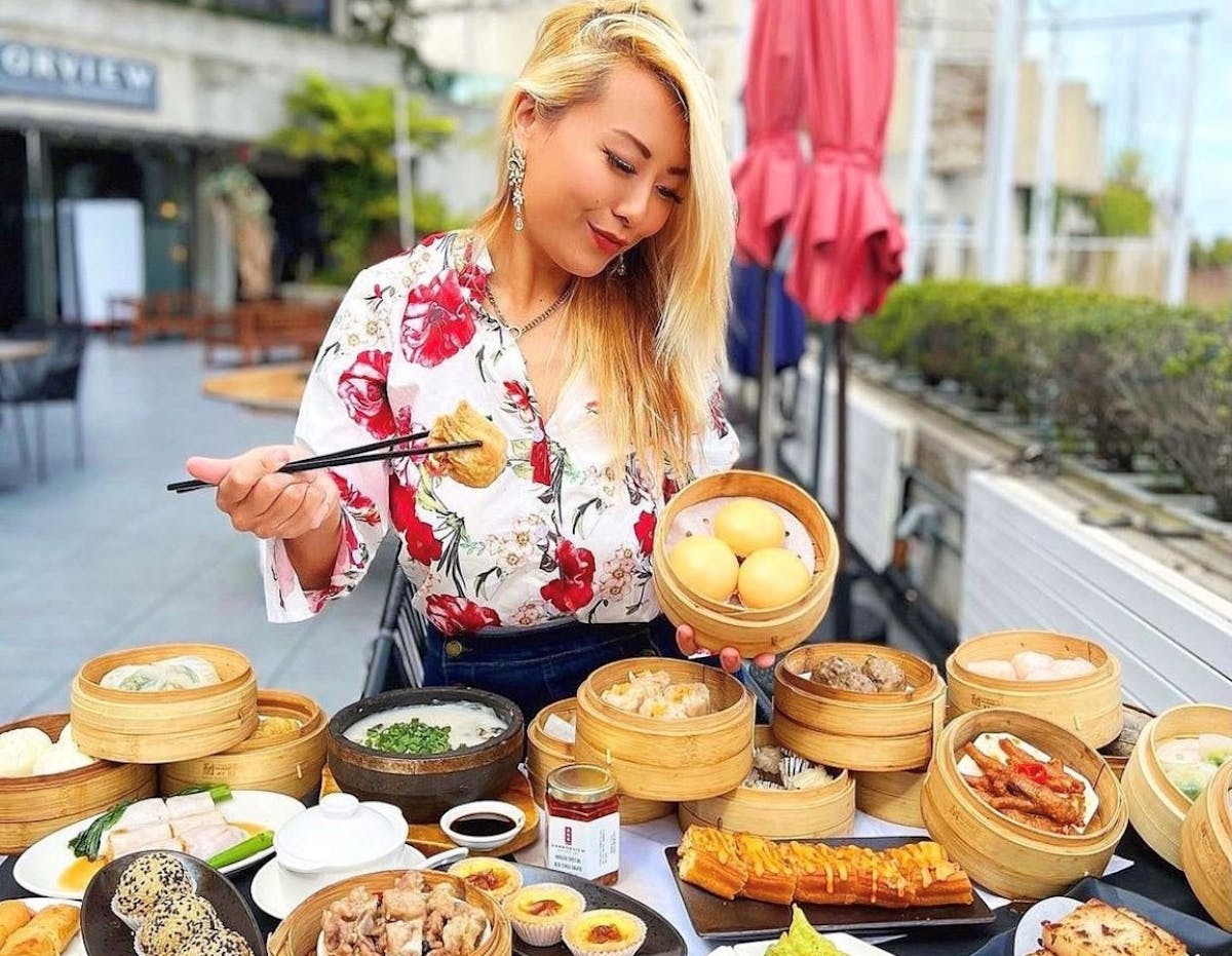 a woman sitting at a table with a plate of food