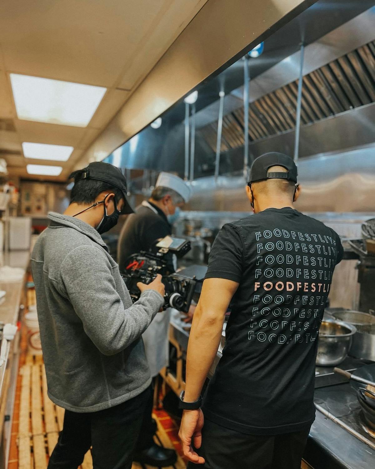 a group of people standing in a kitchen