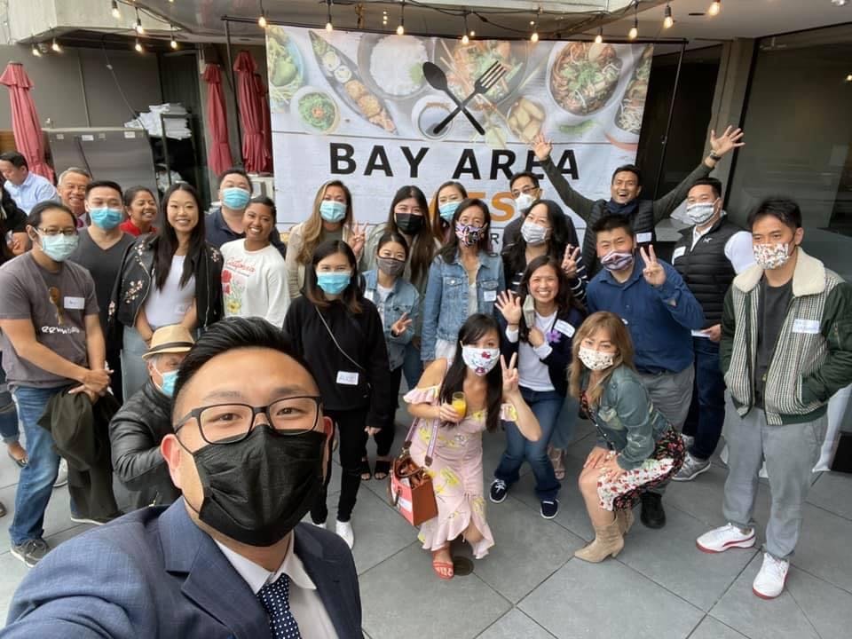 a group of people standing in front of a crowd posing for the camera