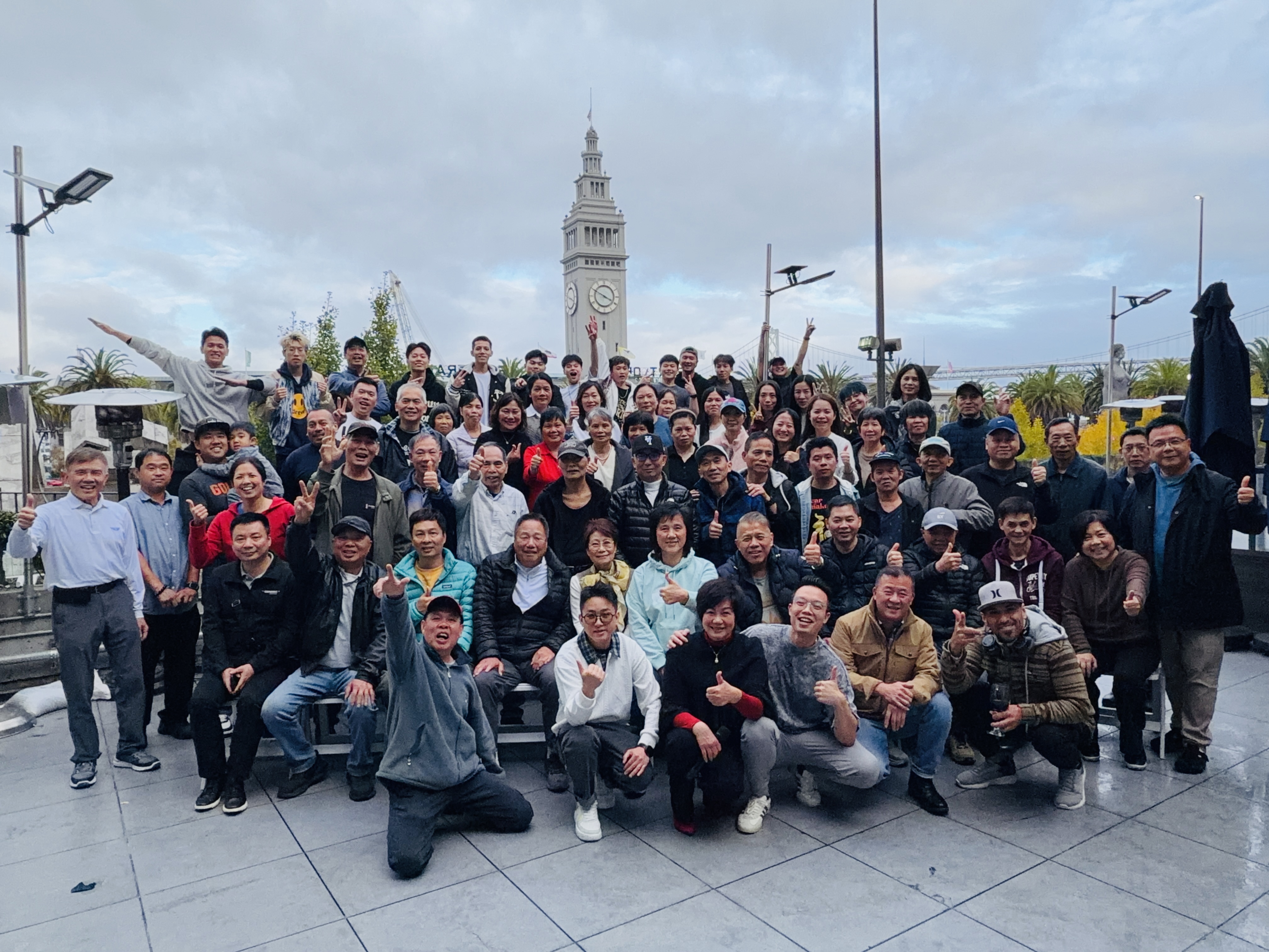 a group of people standing in front of a crowd posing for the camera