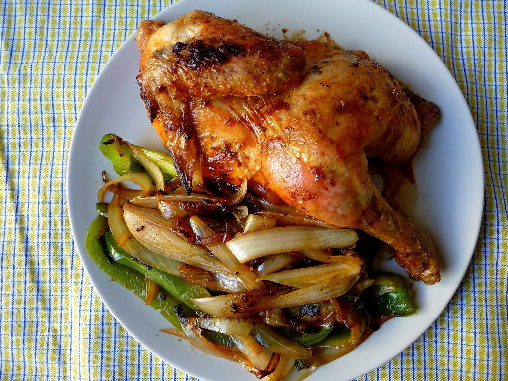 a white plate topped with meat and vegetables