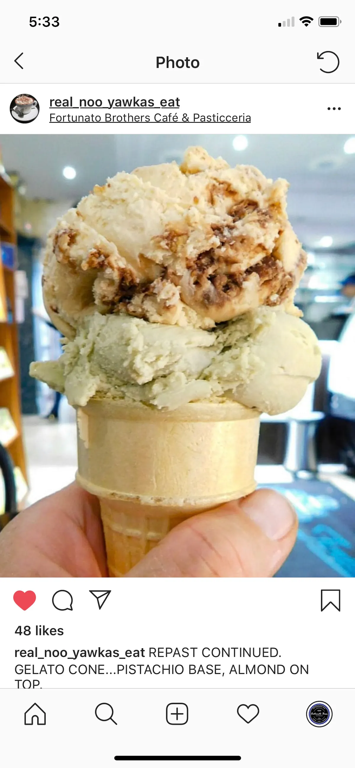 a hand holding an ice cream cone