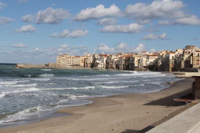 a sandy beach next to the ocean