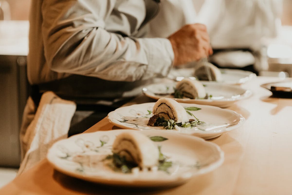 a person sitting at a table with a plate of food