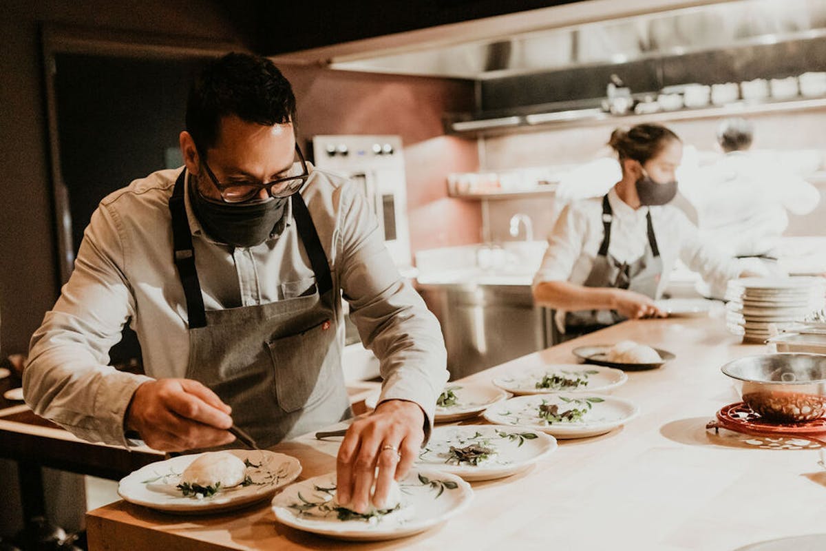 a person sitting at a table with a plate of food