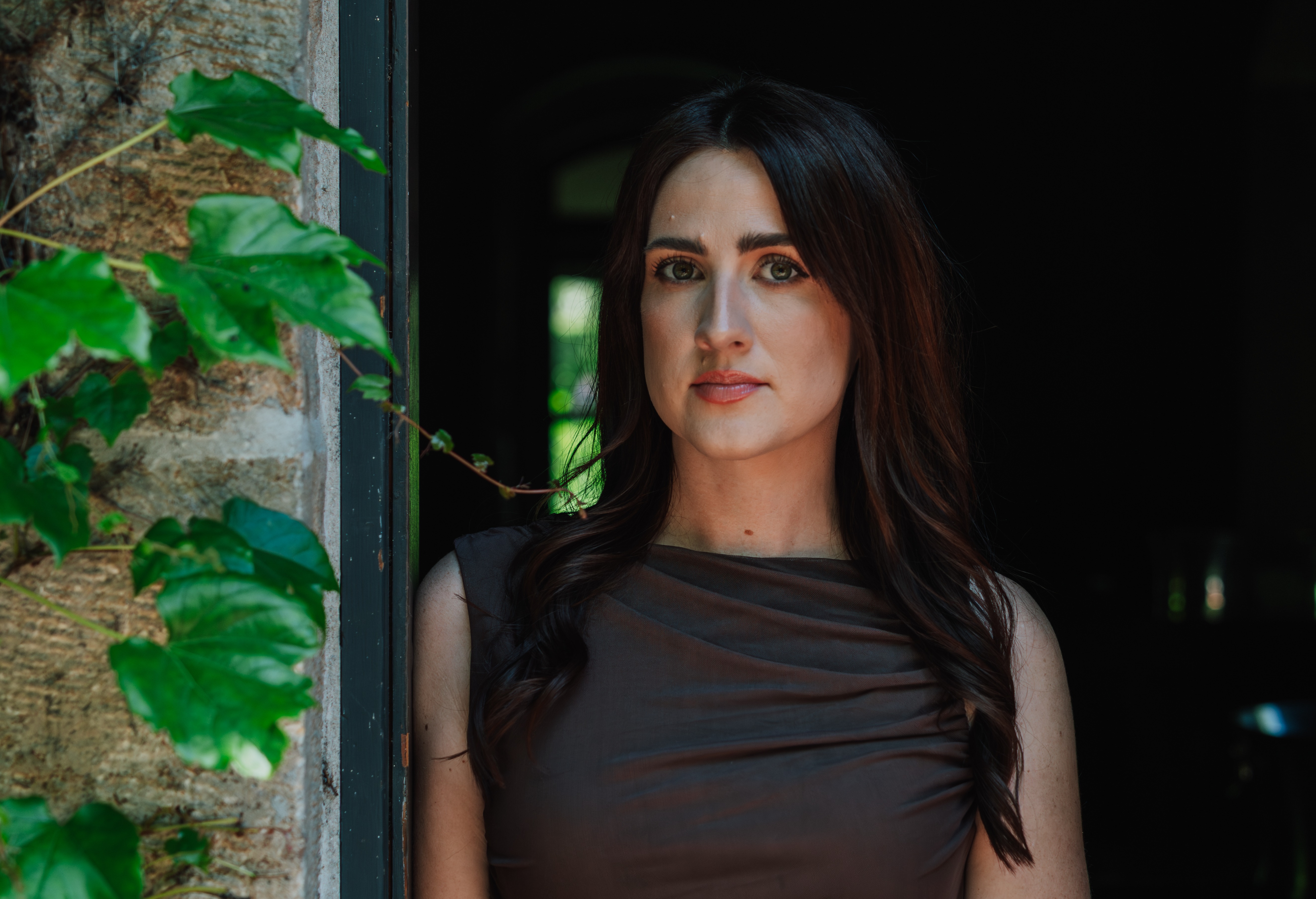 a woman standing in front of a window