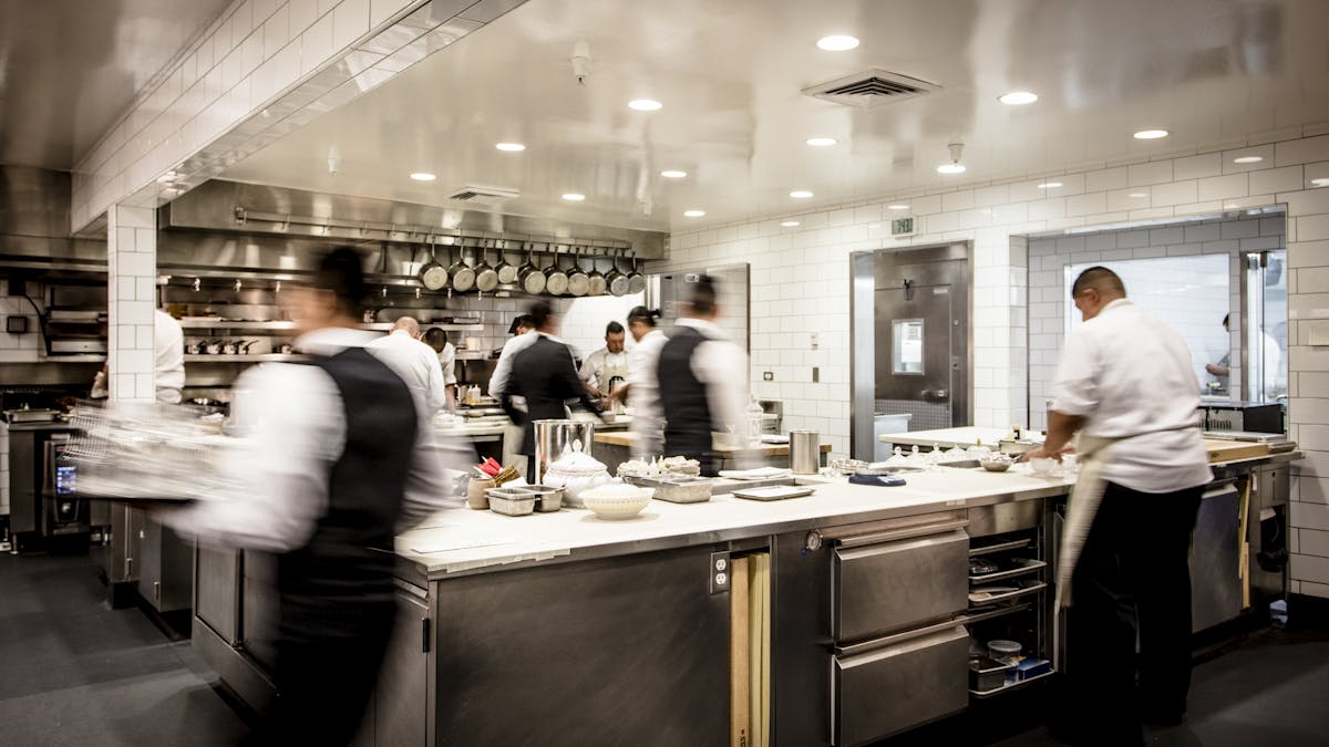 a man cooking in a kitchen preparing food