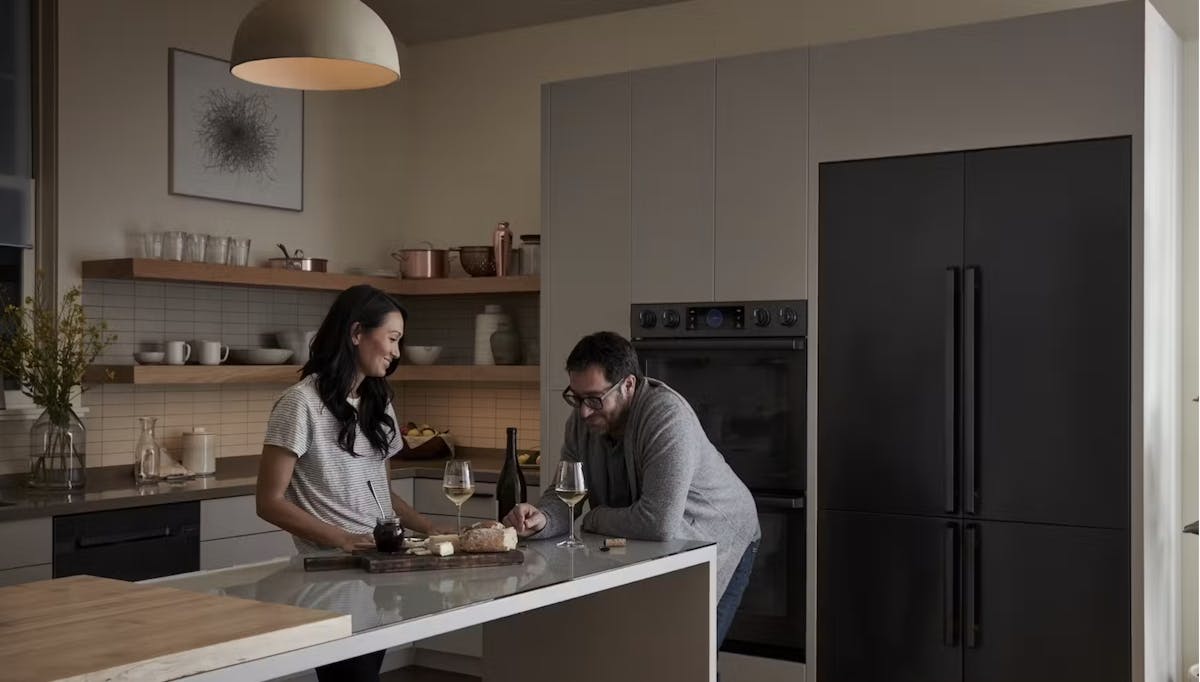 a man and a woman standing in a kitchen