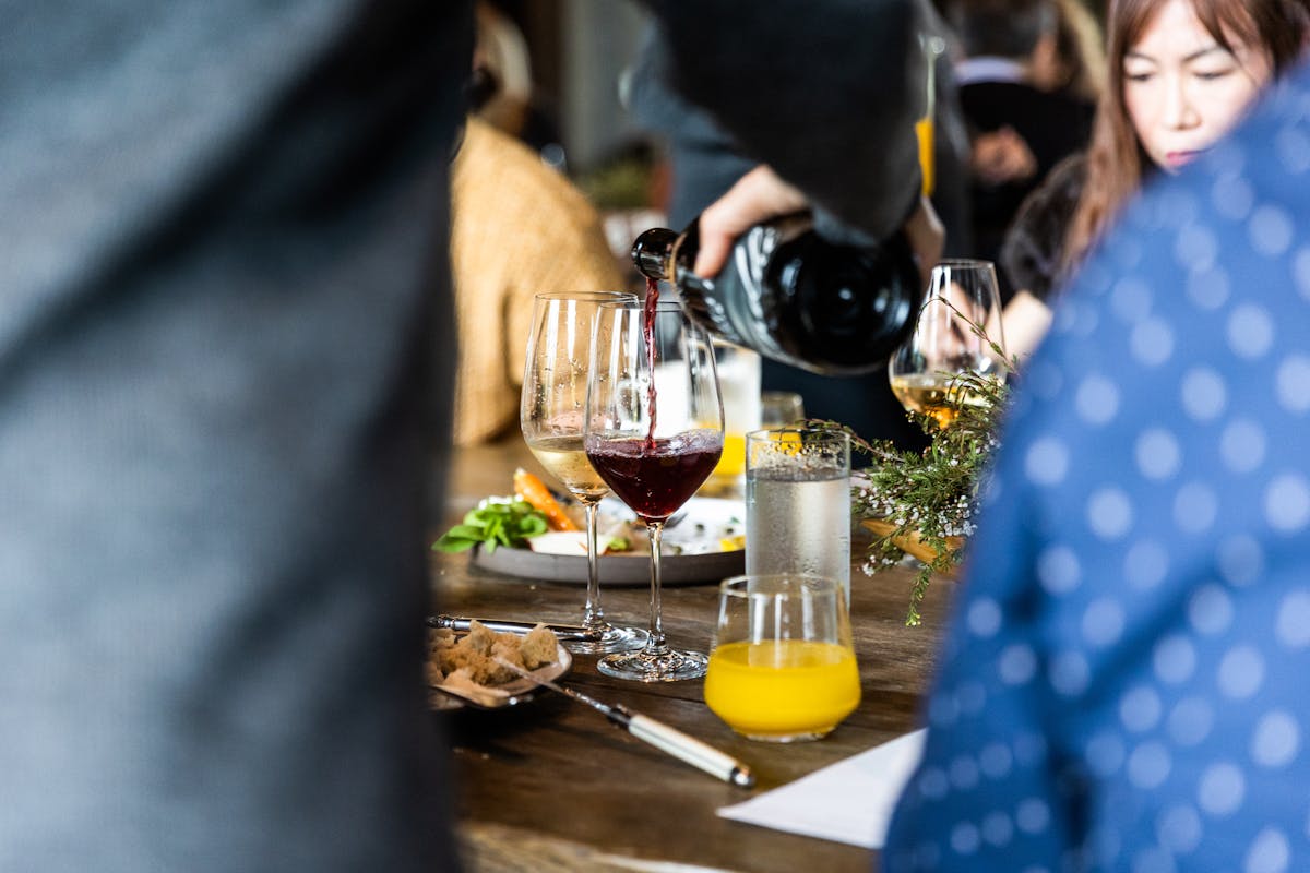 red wine being poured at a table