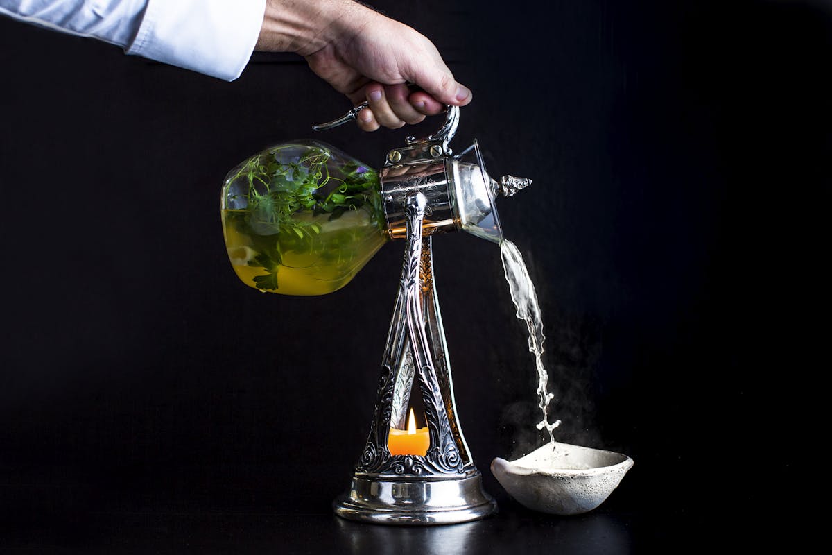 a person pouring a drink