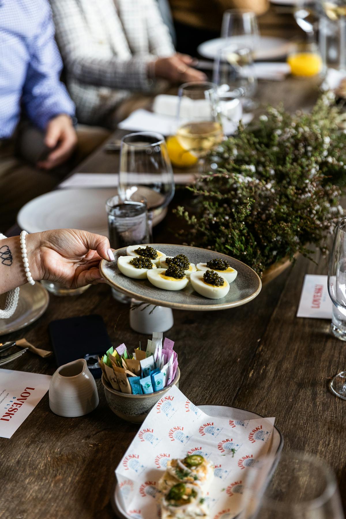 loveski plate of food being passed across a table
