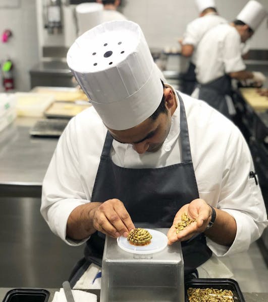 a person holding a tray of food