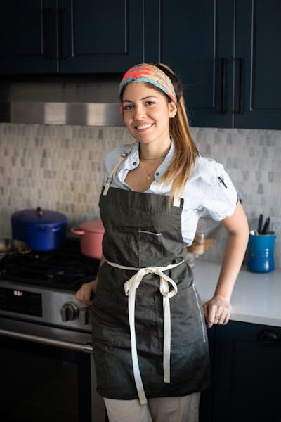 a woman standing in a kitchen