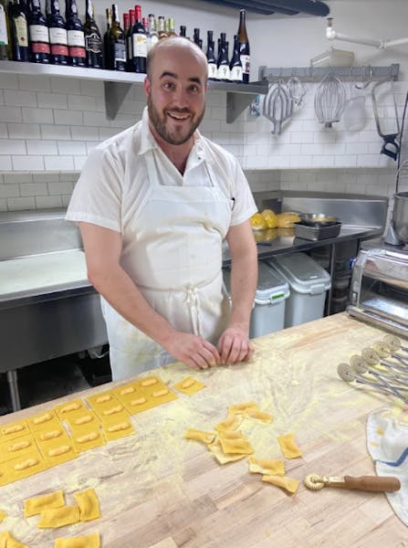 a man cooking in a kitchen preparing food