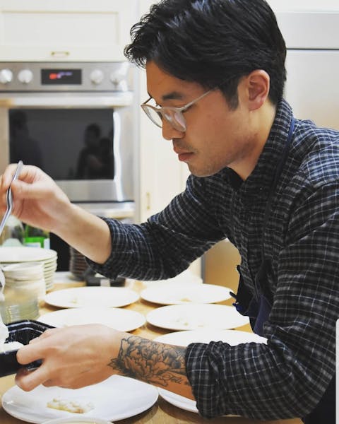 a person cooking in a kitchen preparing food