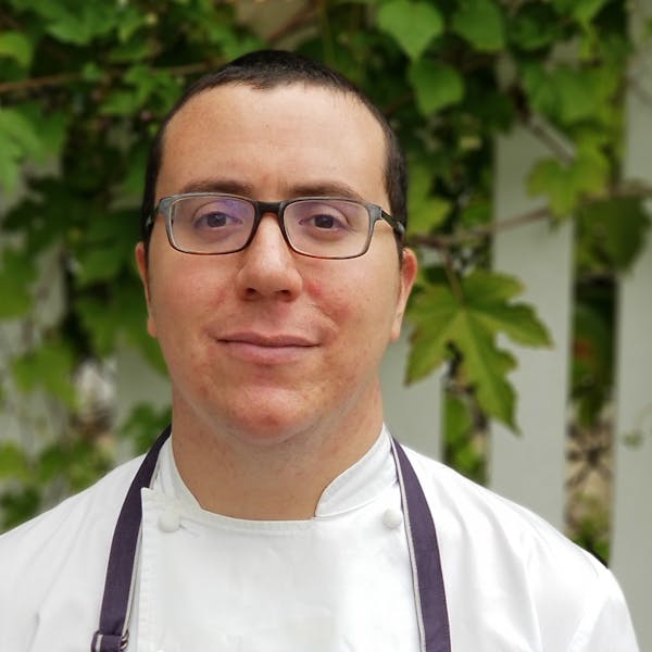a man wearing glasses posing for the camera