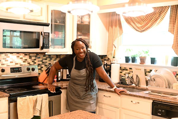 a woman preparing food in a kitchen