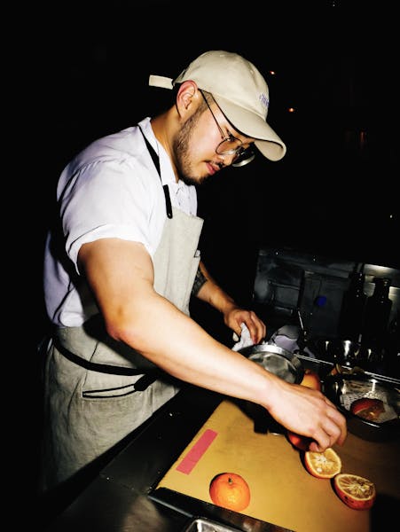 a man standing on top of a cutting board