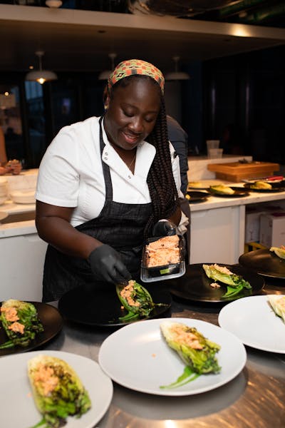 a woman sitting at a table with a plate of food