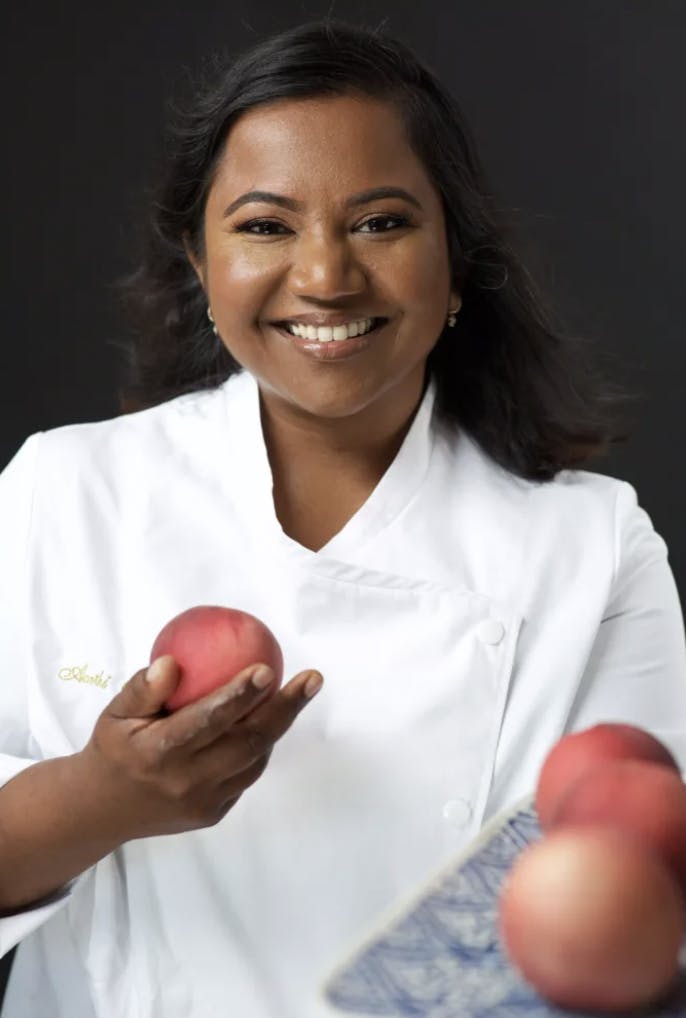 a person holding an apple