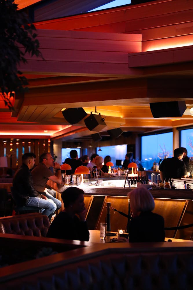 a group of people sitting at a table in a restaurant