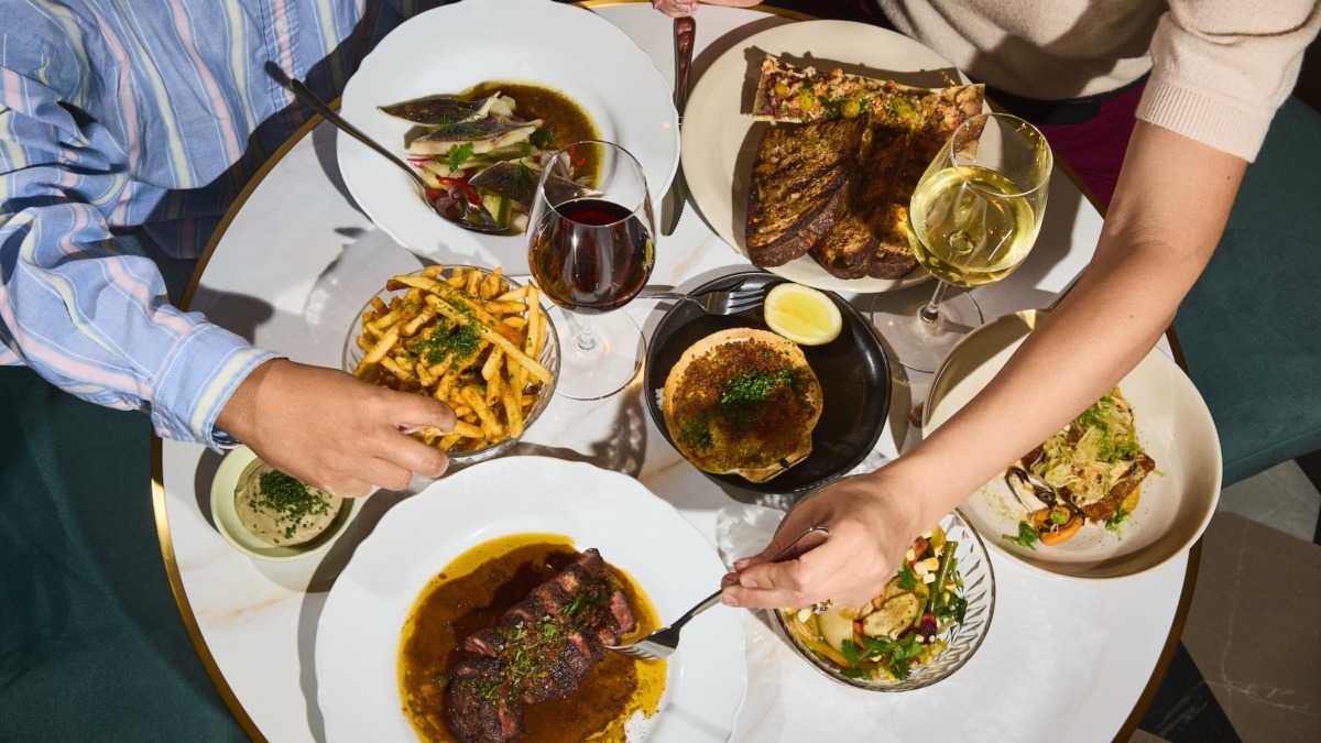 a person sitting at a table with a plate of food