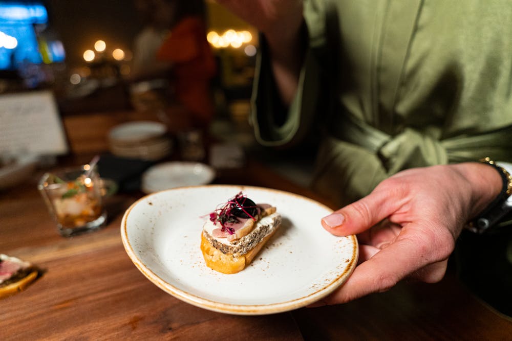 a man sitting at a table with a cake on a plate