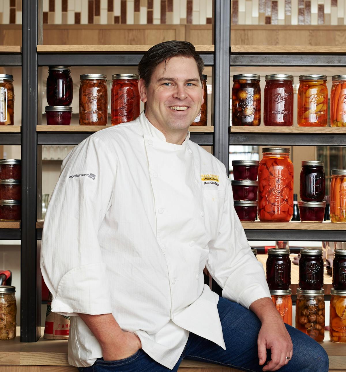 Matt Christianson standing next to a bottle of wine