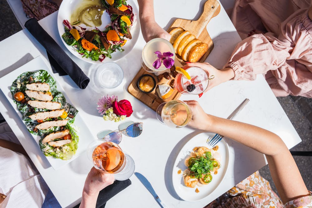 a person sitting at a table with a plate of food