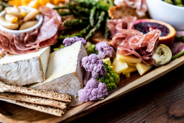 a wooden table topped with different types of food