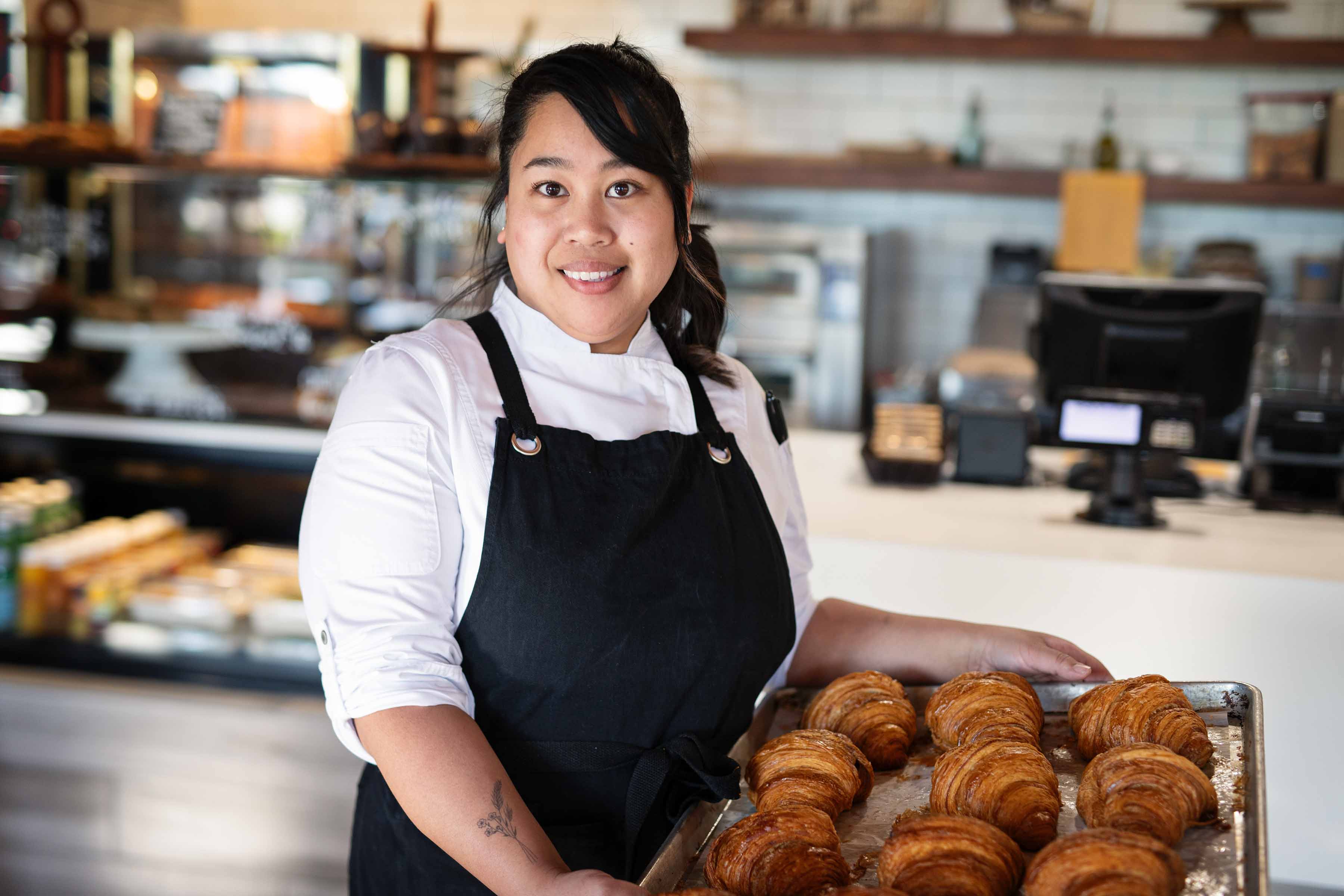 a woman holding a donut