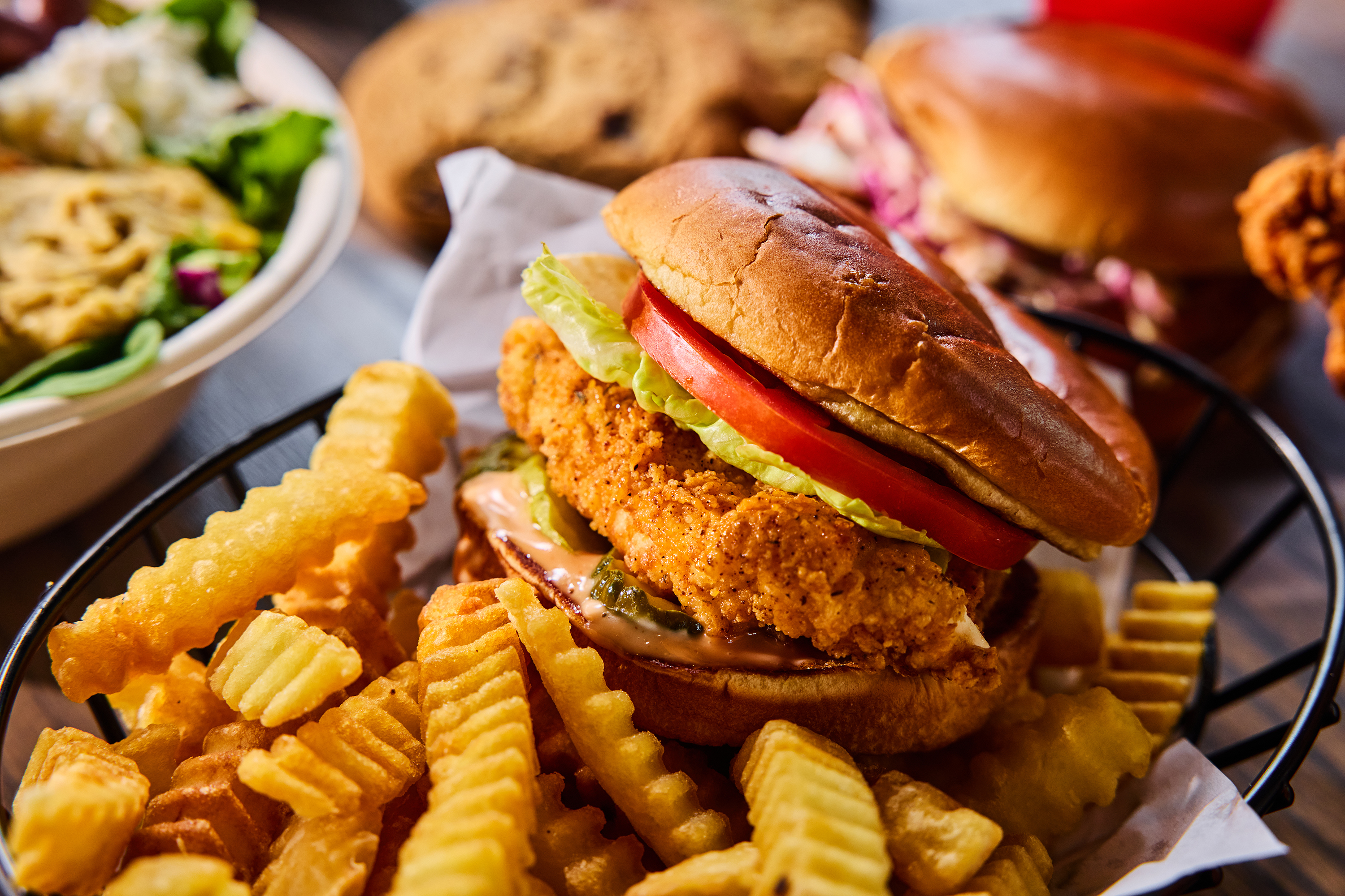 a plate of food with a sandwich and fries on a table