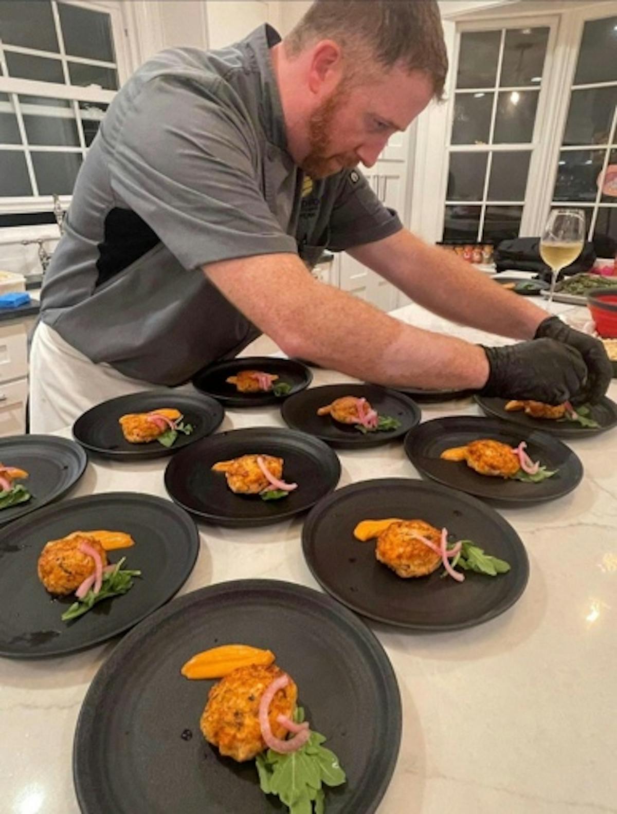 a man sitting at a table with a plate of food