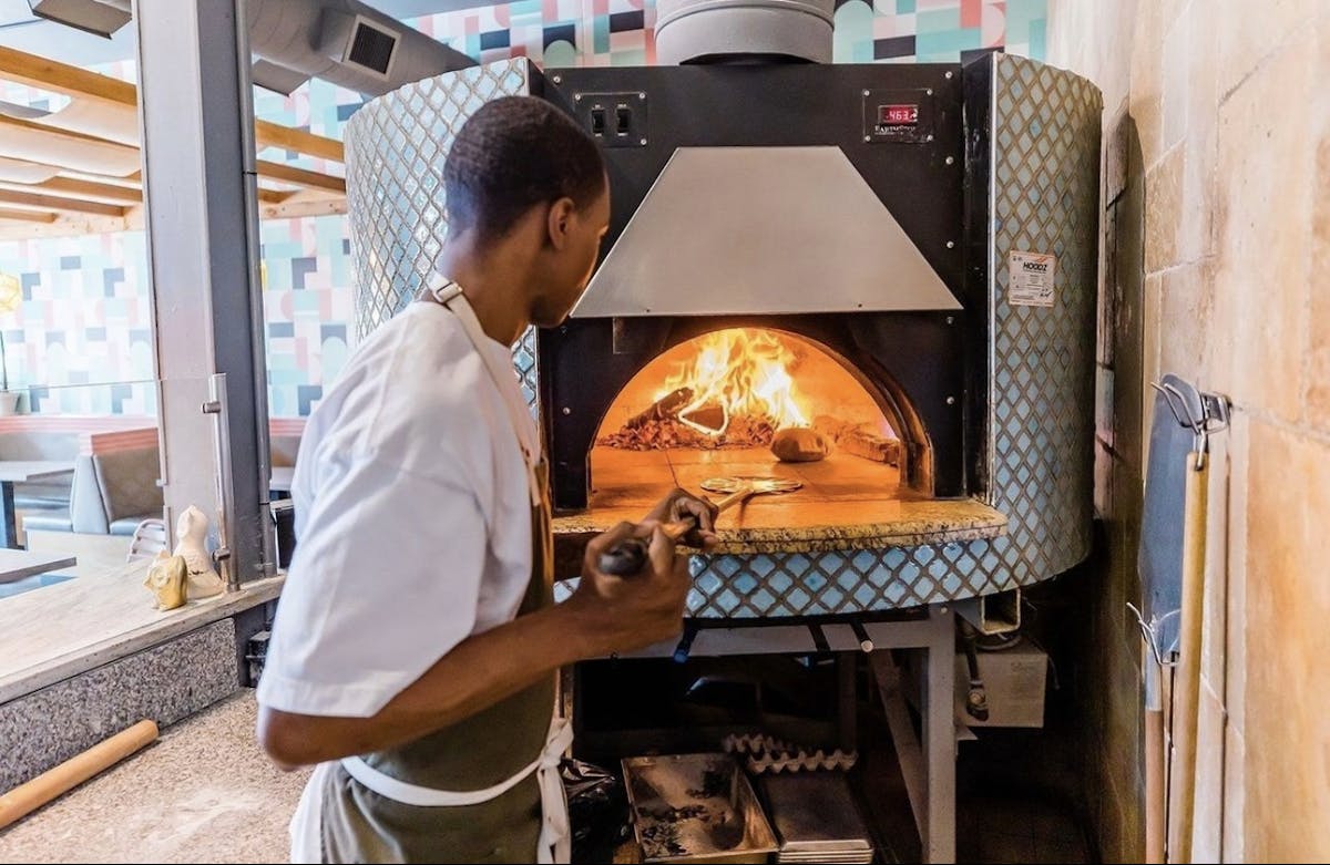a man standing in front of an oven
