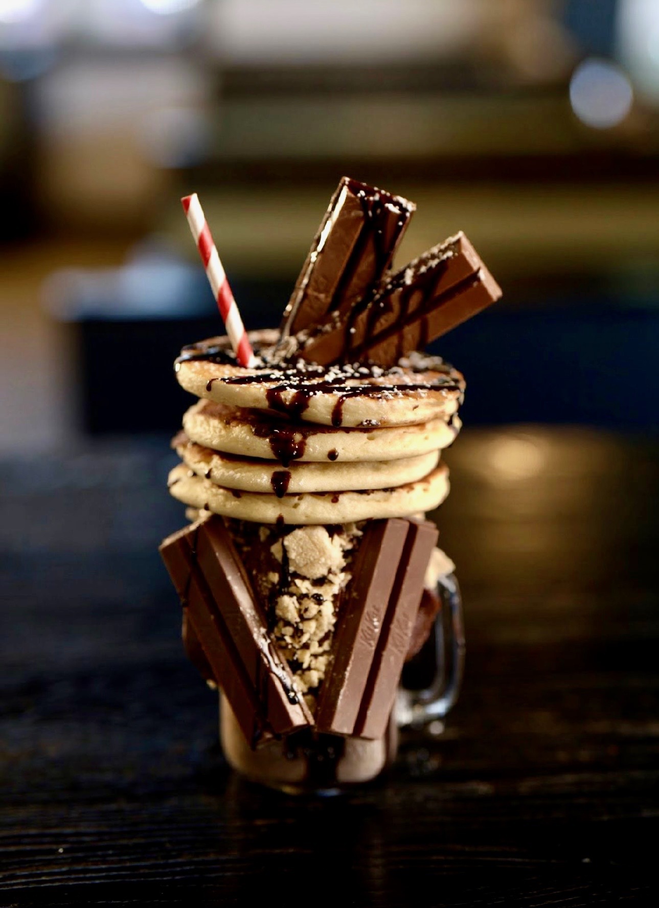 a glass with a milkshake with cookies and chocolate