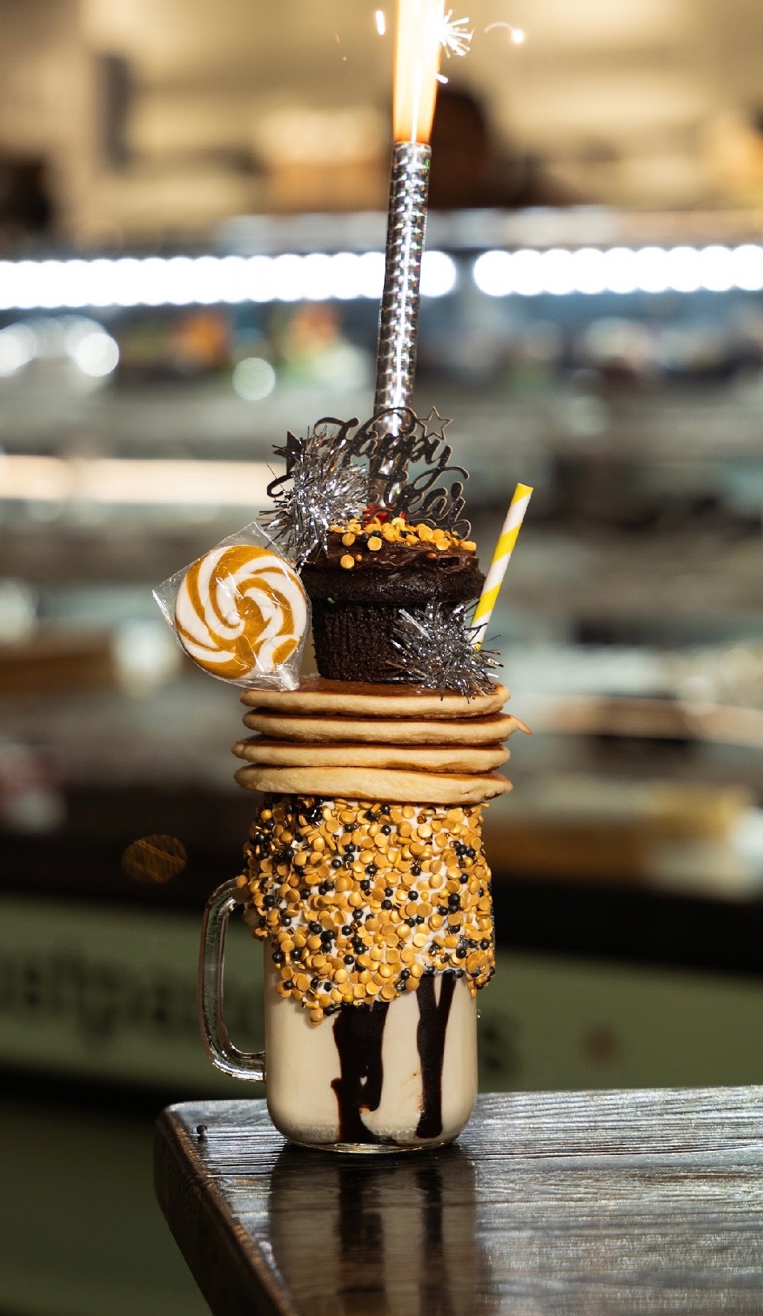 a train cake sitting on top of a wooden table
