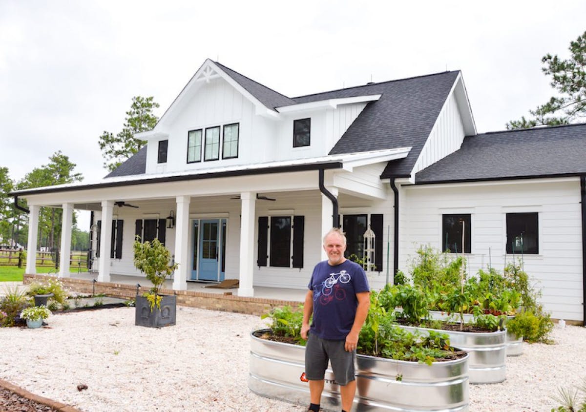 a man standing in front of a house