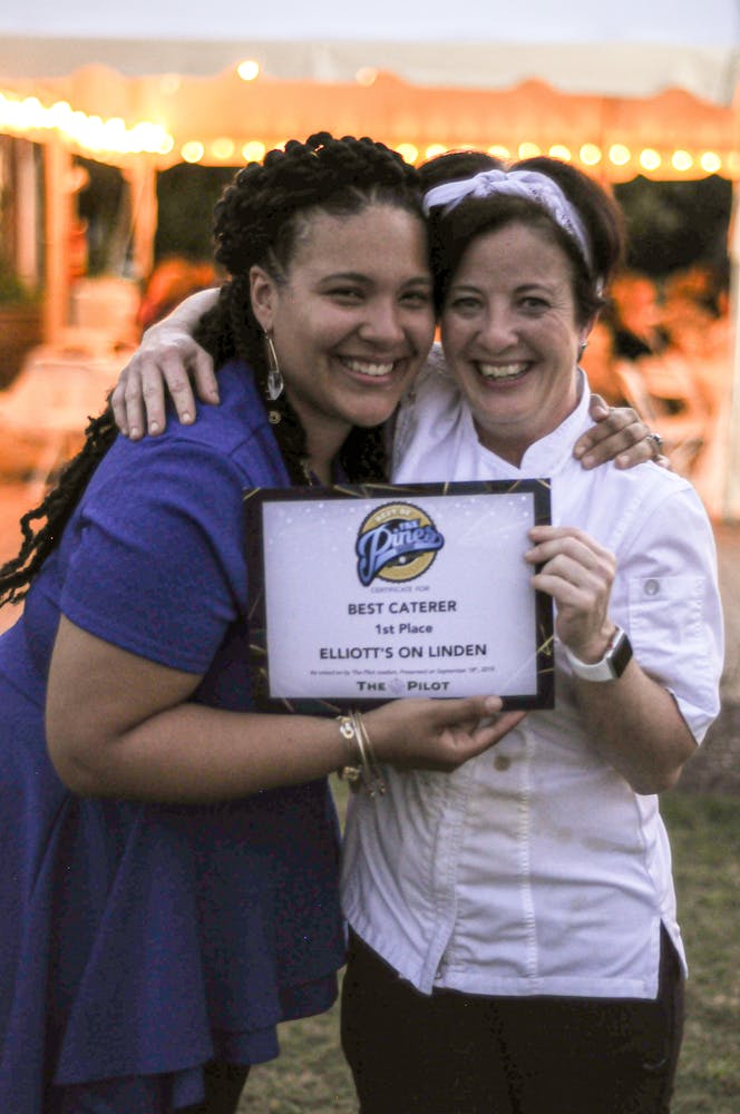 Linda Bennett holding a sign posing for the camera