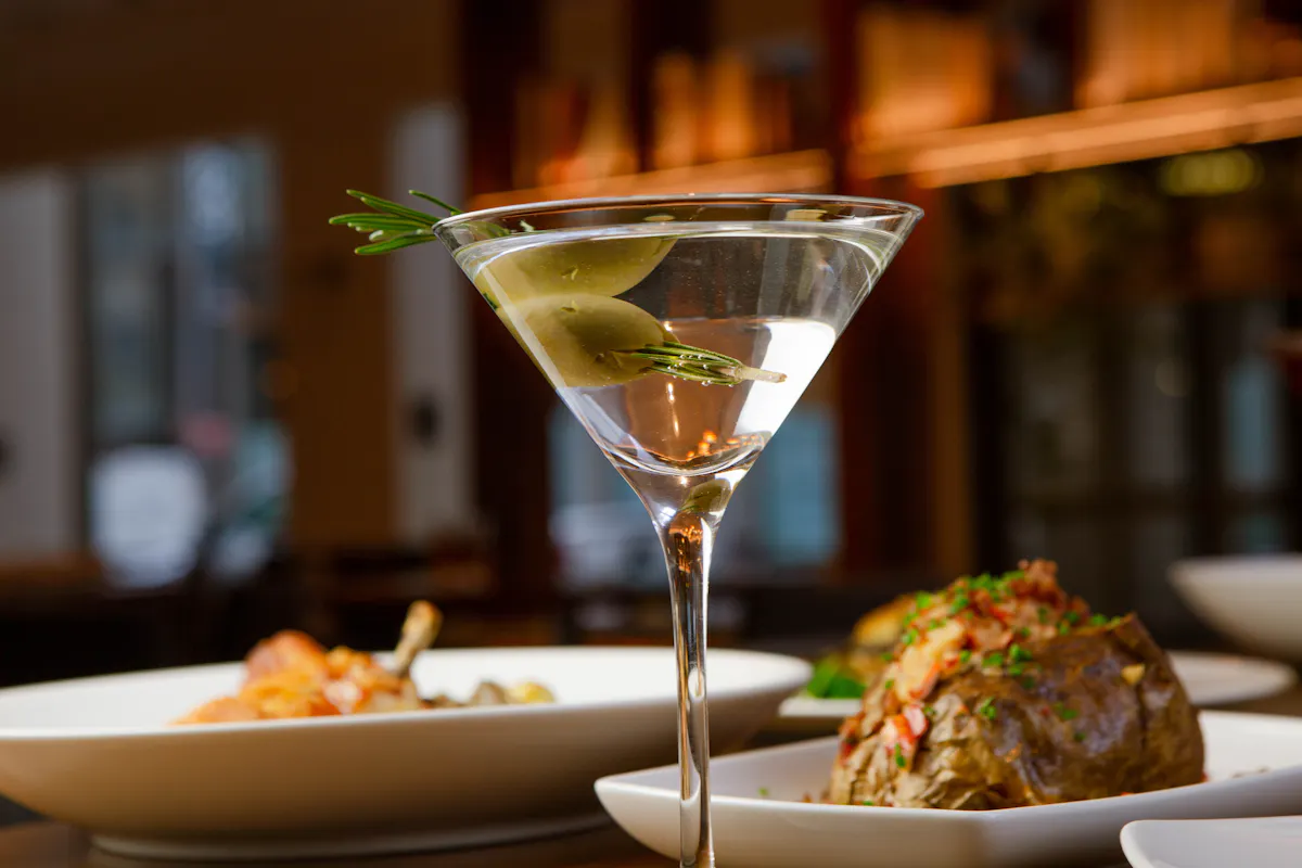 a close up of a plate of food and a glass of wine