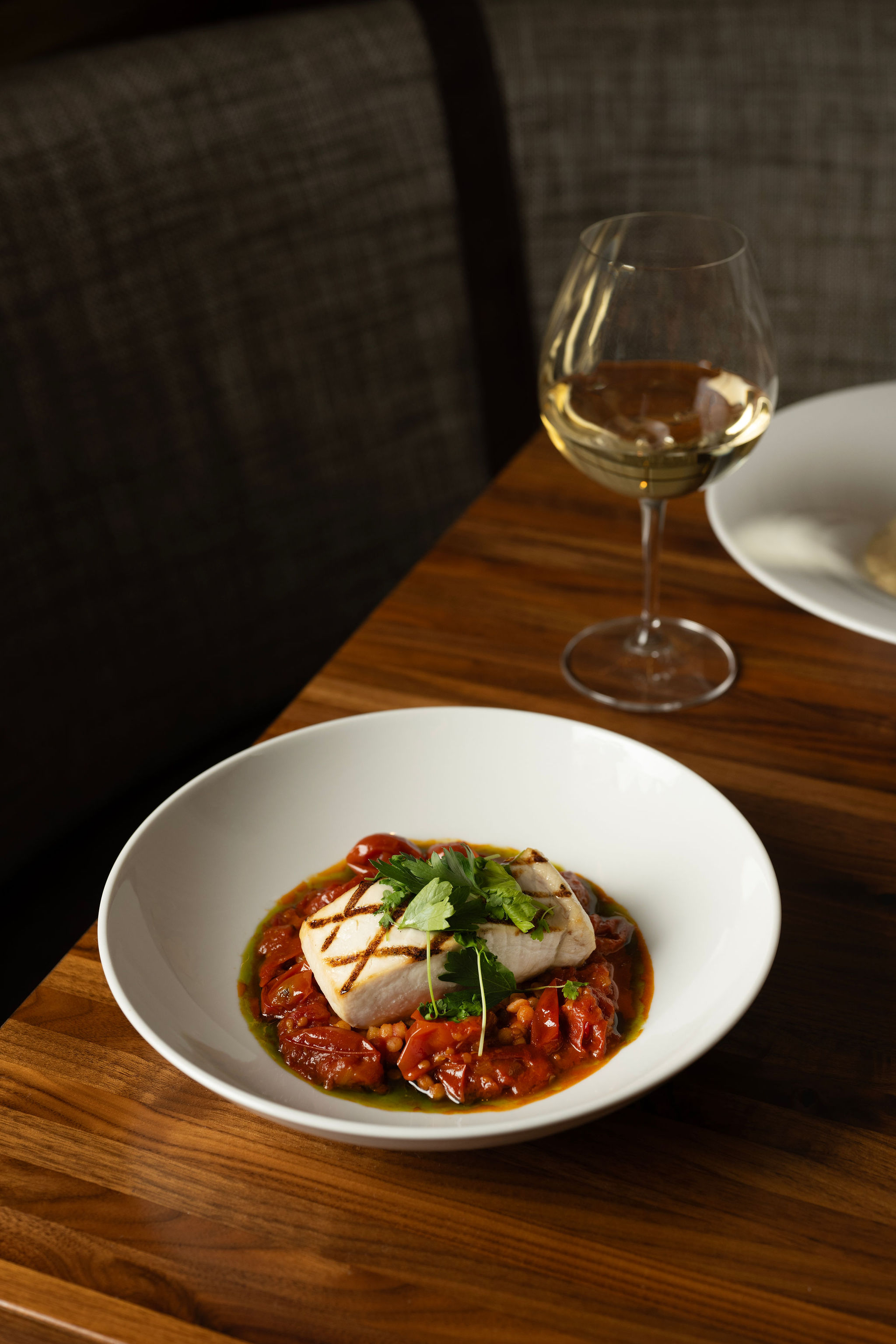 a plate of food and glasses of wine on a table