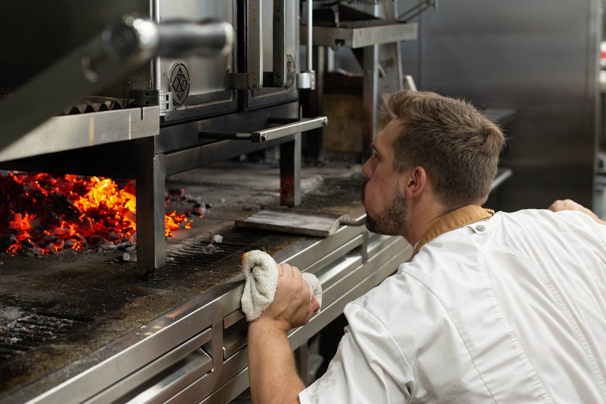 a man standing in front of an oven